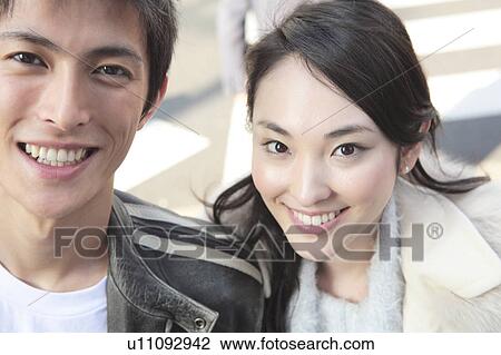 Stock Image - Smiling Japanese couple. Fotosearch