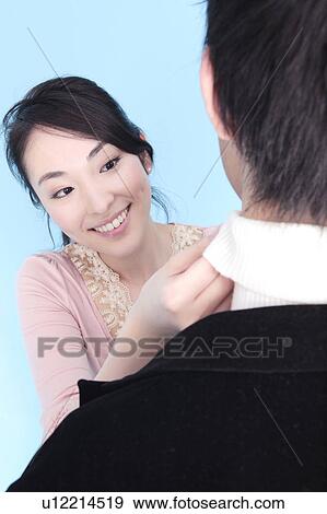 Stock Photo - Straighten necktie of lover. Fotosearch