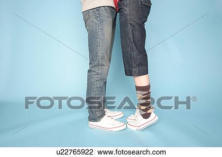 Stock Image - Waist down view of embracing couple. Fotosearch