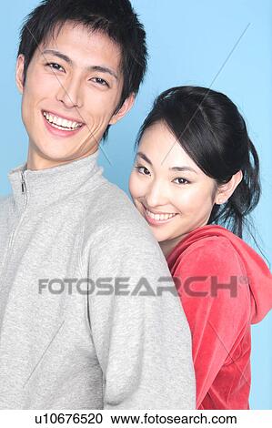 Stock Image - Woman embracing a lover from back. Fotosearch