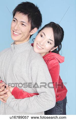 Stock Photo - Woman embracing a lover from back. Fotosearch