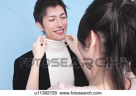 Woman straighten around neck of lover View Large Photo Image Stock Photography - Woman straighten around neck of lover. Fotosearch