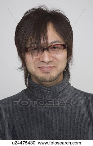 Stock Image - Portrait of a mid adult man in polo neck. Fotosearch
