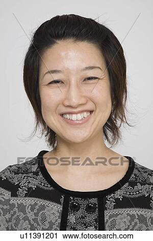 Stock Image - Portrait of a mid adult woman. Fotosearch