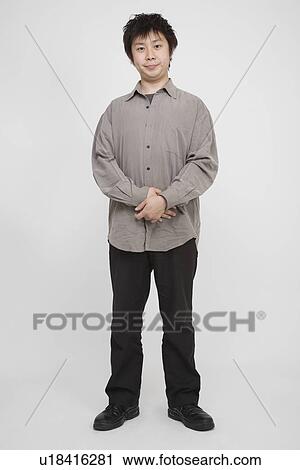 Portrait of a mid adult man standing View Large Photo Image Stock Image - Portrait of a mid adult man standing. Fotosearch