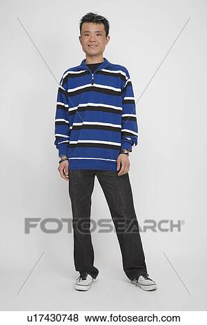 Stock Photo - Portrait of a mid adult man standing. Fotosearch