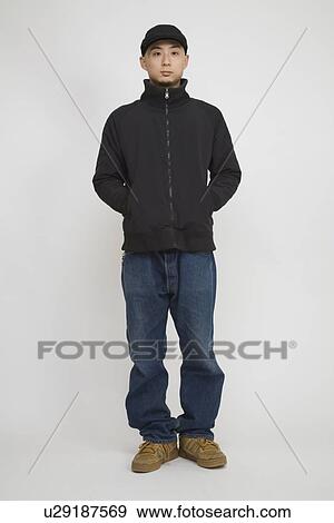 Stock Photo - Portrait of a mid adult man standing. Fotosearch