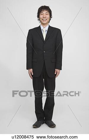 Stock Photography - Portrait of a mid adult man standing. Fotosearch