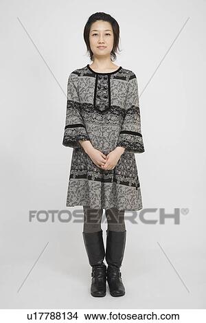 Portrait of a mid adult woman standing View Large Photo Image Picture - Portrait of a mid adult woman standing. Fotosearch