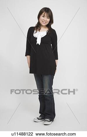 Portrait of a mid adult woman standing View Large Photo Image Stock Image - Portrait of a mid adult woman standing. Fotosearch
