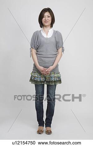 Portrait of a mid adult woman standing View Large Photo Image Stock Image - Portrait of a mid adult woman standing. Fotosearch