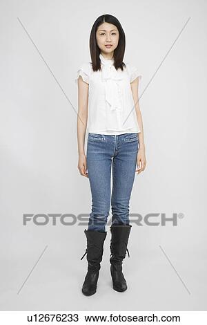Stock Image - Portrait of a mid adult woman standing. Fotosearch