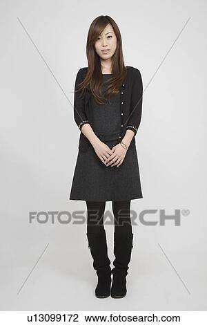 Portrait of a mid adult woman standing View Large Photo Image Stock Image - Portrait of a mid adult woman standing. Fotosearch
