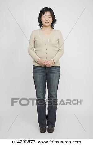 Portrait of a mid adult woman standing View Large Photo Image Stock Image - Portrait of a mid adult woman standing. Fotosearch
