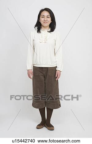 Portrait of a mid adult woman standing View Large Photo Image Stock Image - Portrait of a mid adult woman standing. Fotosearch
