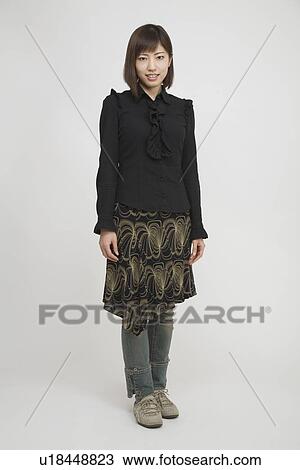 Portrait of a mid adult woman standing View Large Photo Image Stock Image - Portrait of a mid adult woman standing. Fotosearch