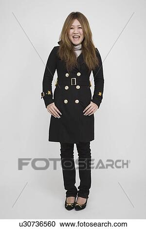 Portrait of a mid adult woman standing View Large Photo Image Stock Image - Portrait of a mid adult woman standing. Fotosearch