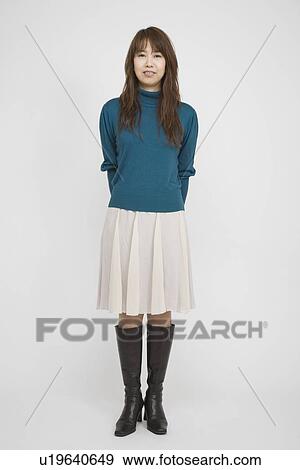Stock Photo - Portrait of a mid adult woman standing. Fotosearch