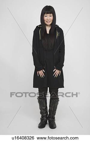 Portrait of a mid adult woman standing View Large Photo Image Stock Photograph - Portrait of a mid adult woman standing. Fotosearch