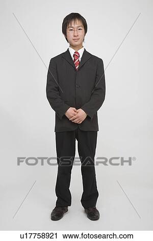 Stock Image - Portrait of a young man standing. Fotosearch