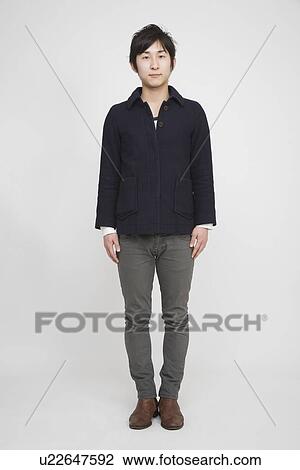 Portrait of a young man standing View Large Photo Image Stock Image - Portrait of a young man standing. Fotosearch