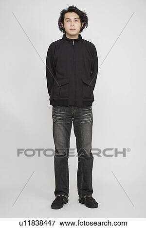 Portrait of a young man standing View Large Photo Image Stock Photo - Portrait of a young man standing. Fotosearch