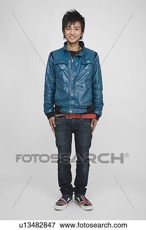 Portrait of a young man standing View Large Photo Image Stock Photo - Portrait of a young man standing. Fotosearch