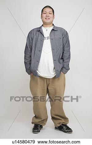 Stock Photo - Portrait of a young man standing. Fotosearch