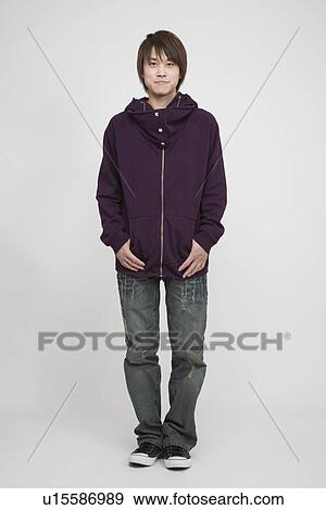 Portrait of a young man standing View Large Photo Image Stock Photo - Portrait of a young man standing. Fotosearch