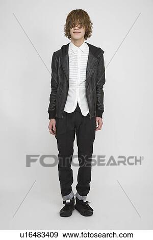 Portrait of a young man standing View Large Photo Image Stock Photo - Portrait of a young man standing. Fotosearch