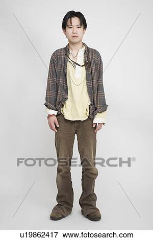 Portrait of a young man standing View Large Photo Image Stock Photo - Portrait of a young man standing. Fotosearch