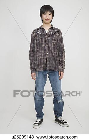 Stock Photo - Portrait of a young man standing. Fotosearch