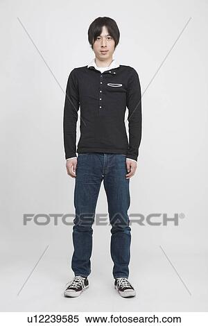 Stock Photography - Portrait of a young man standing. Fotosearch