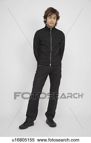 Stock Photography - Portrait of a young man standing. Fotosearch