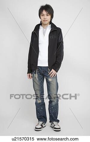 Stock Photography - Portrait of a young man standing. Fotosearch
