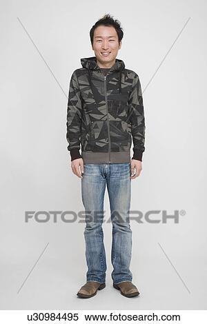 Stock Photography - Portrait of a young man standing. Fotosearch