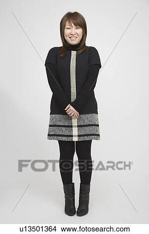 Portrait of a young woman standing View Large Photo Image Picture - Portrait of a young woman standing. Fotosearch