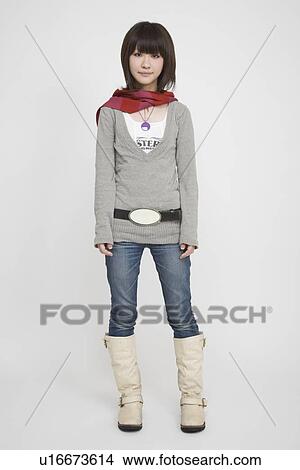 Portrait of a young woman standing View Large Photo Image Picture - Portrait of a young woman standing. Fotosearch