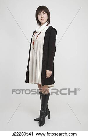Portrait of a young woman standing View Large Photo Image Stock Image - Portrait of a young woman standing. Fotosearch