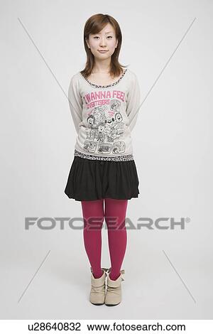 Portrait of a young woman standing View Large Photo Image Stock Image - Portrait of a young woman standing. Fotosearch