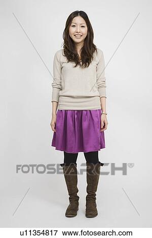 Stock Photo - Portrait of a young woman standing. Fotosearch