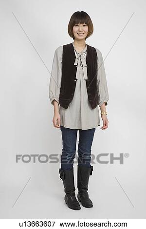 Stock Photo - Portrait of a young woman standing. Fotosearch