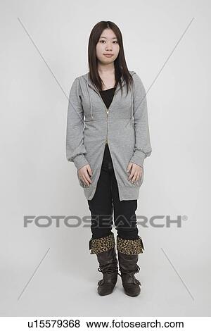 Stock Photo - Portrait of a young woman standing. Fotosearch