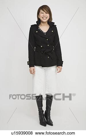 Stock Photo - Portrait of a young woman standing. Fotosearch