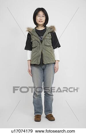 Stock Photo - Portrait of a young woman standing. Fotosearch