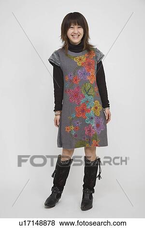 Stock Photo - Portrait of a young woman standing. Fotosearch