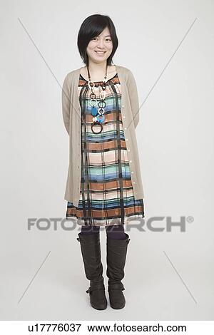Stock Photo - Portrait of a young woman standing. Fotosearch