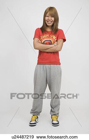Portrait of a young woman standing View Large Photo Image Stock Photo - Portrait of a young woman standing. Fotosearch