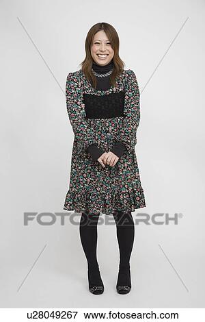 Portrait of a young woman standing View Large Photo Image Stock Photo - Portrait of a young woman standing. Fotosearch