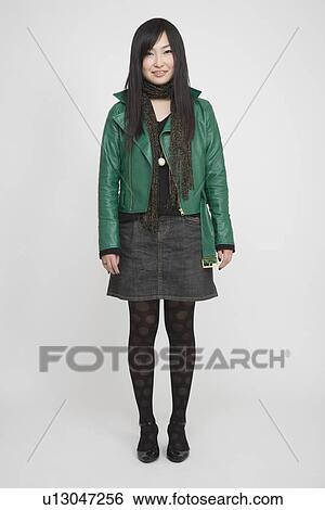 Stock Photograph - Portrait of a young woman standing. Fotosearch